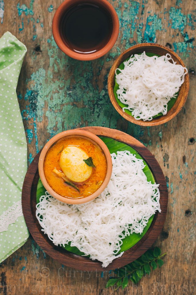 idiyappam or rice string hoppers served on wooden plate with egg stew