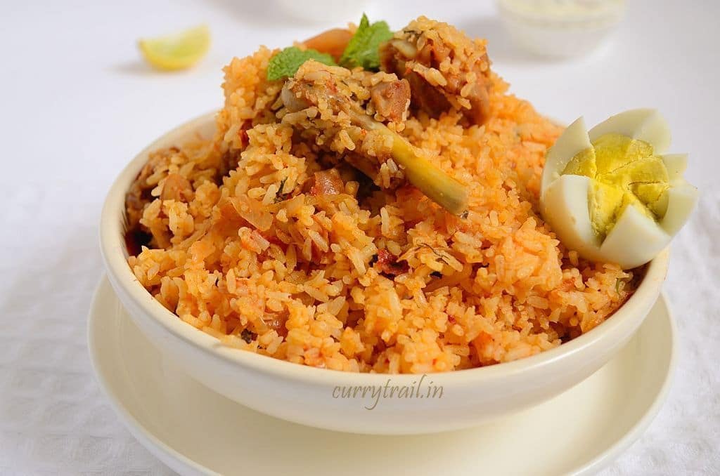 Ambur chicken biryani in a white bowl and chicken leg piece