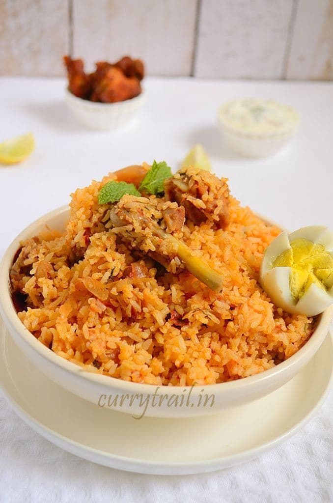 Ambur chicken biryani in a white bowl and boiled egg on top