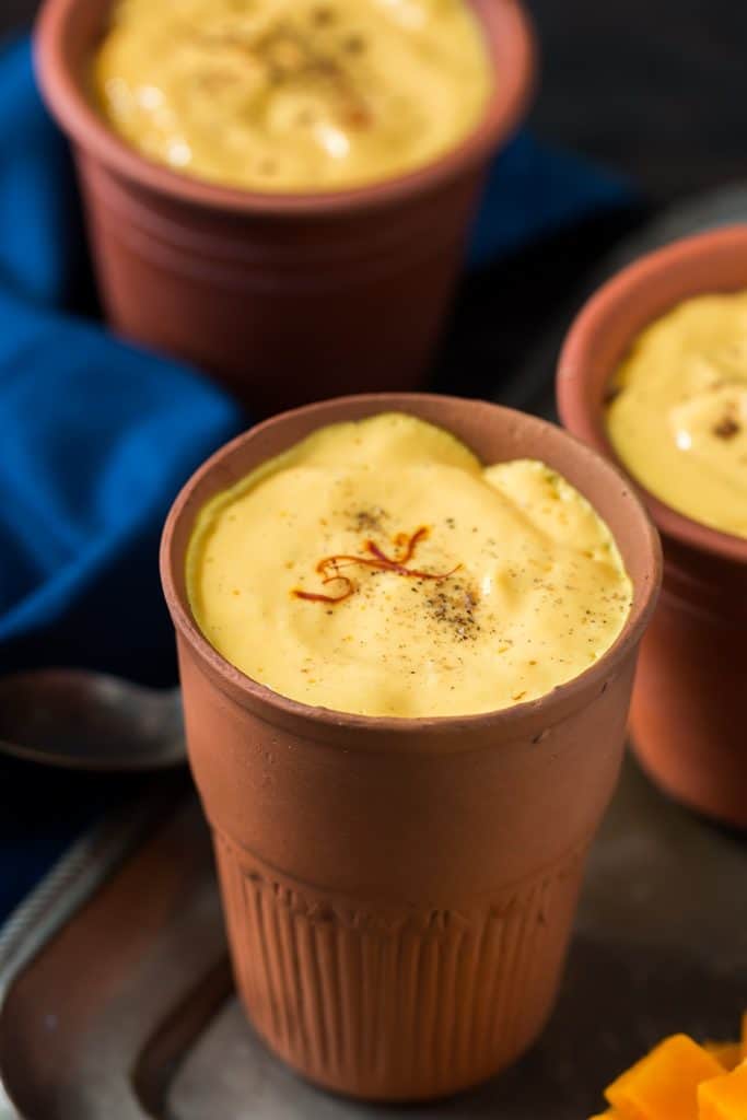 Mango lassi recipe is mango yogurt thick drink served in earthen glass