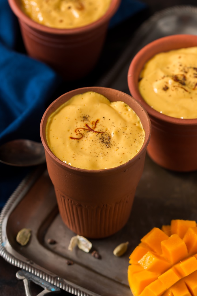 2 glasses of mango lassi recipe served in earthen glass