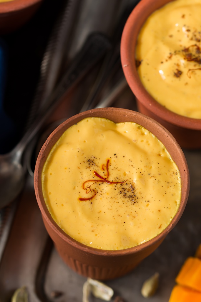 Mango lassi served in clay pots close up