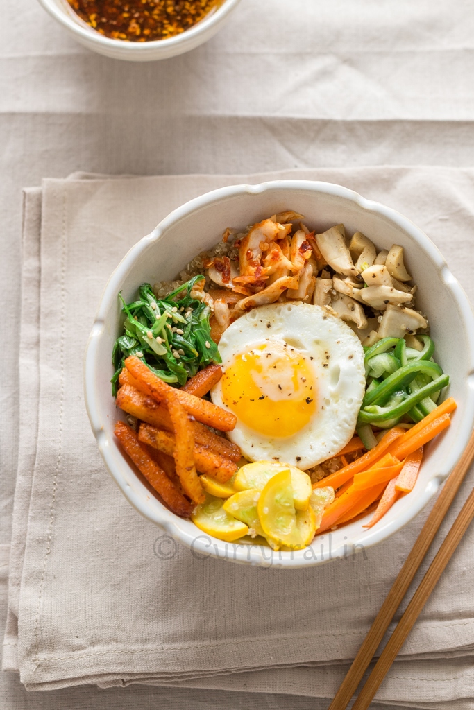 vegetarian Korean bibimbap with quinoa and vegetables in white bowl