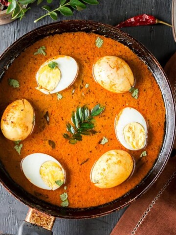 Chettinad egg curry with curry leaves on it