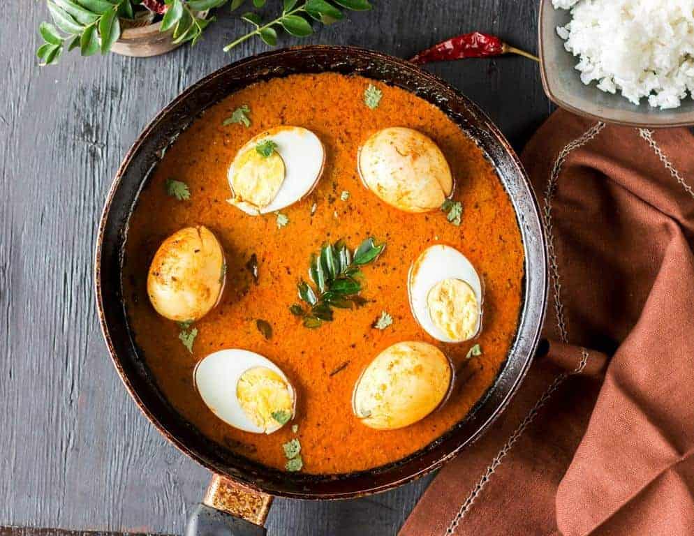 Chettinad egg curry with curry leaves on it