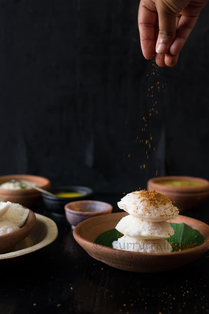 Idli stacked and idli podi sprinkled on top