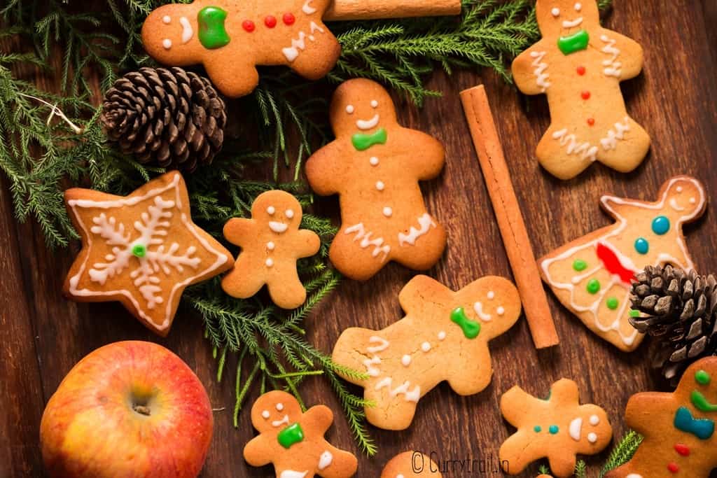 different sized gingerbread man cookies on wooden tray