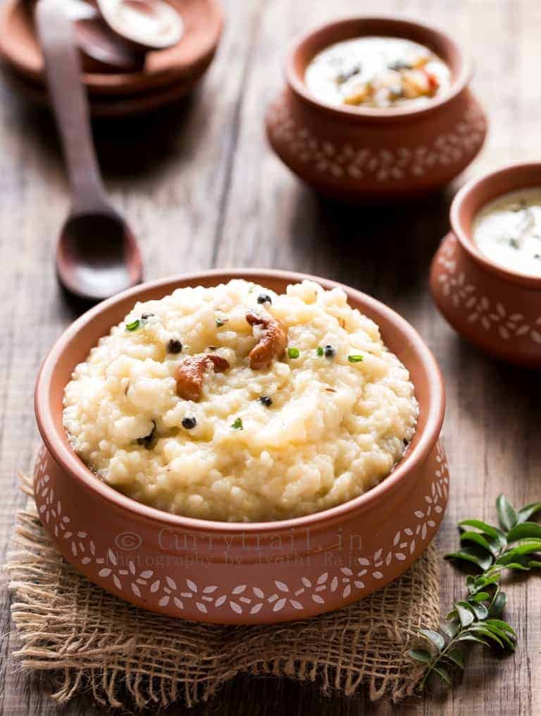 ven pongal is rice and moong dal breakfast dish served in earthen pots along side coconut chutney and sambar
