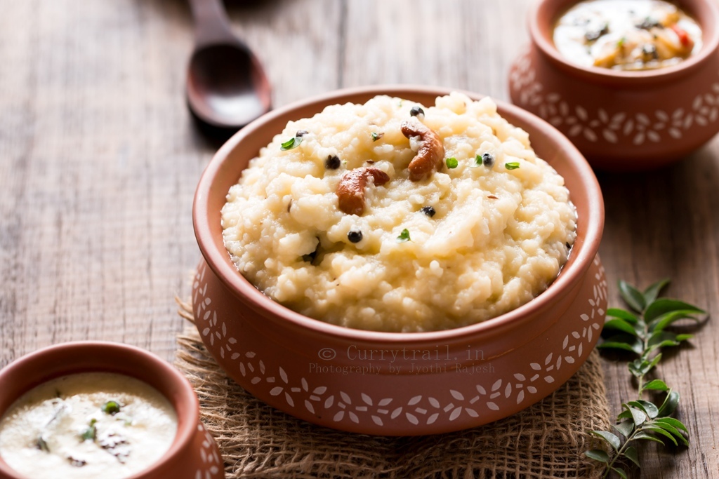 ven pongal is rice and moong dal breakfast dish served in earthen pots along side coconut chutney and sambar