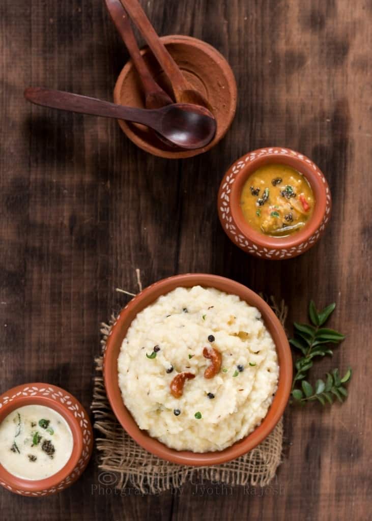 ven pongal is rice and moong dal breakfast dish served in earthen pots along side coconut chutney and sambar