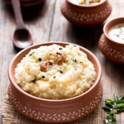 ven pongal is rice and moong dal breakfast dish served in earthen pots along side coconut chutney and sambar