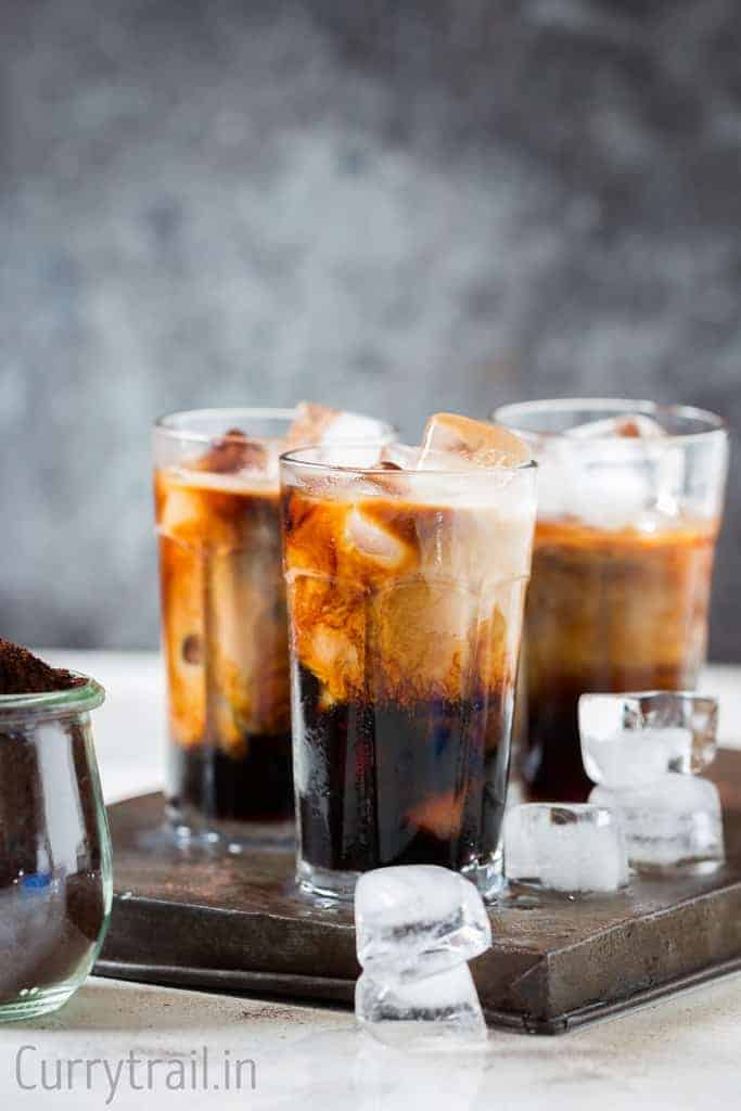 Best-Homemade-Iced-Coffee-with-3-glasses 3 glasses of iced cubes on a table.