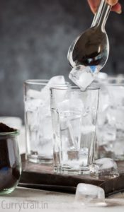 Filling glass with ice for iced coffee recipe