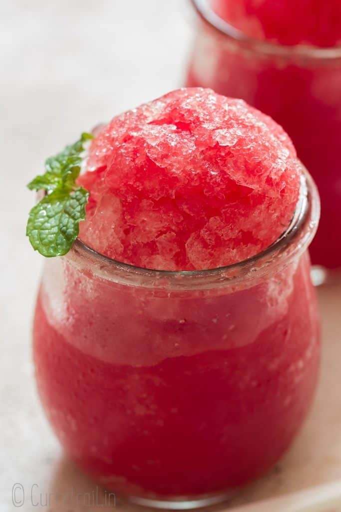 Cool refreshing watermelon granita in glass jars.