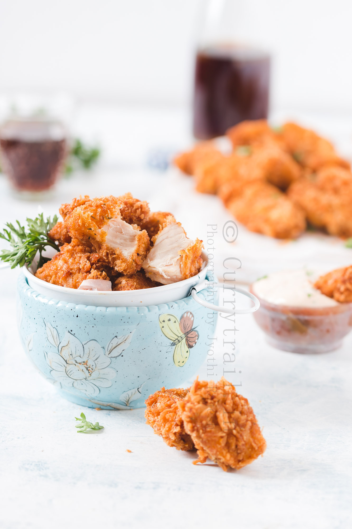 homemade chicken nuggets server in bowl with creamy spicy sauce on the side