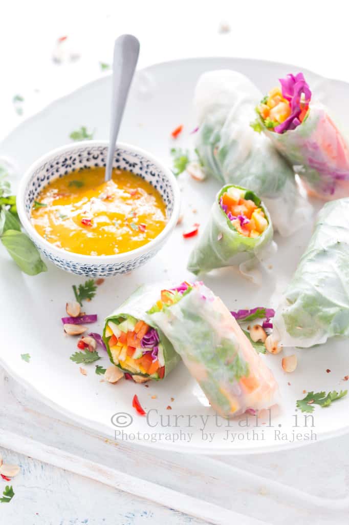 Thai rice paper rolls with mango dipping sauce in white plate