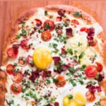 breakfast pizza with eggs and bacon with text