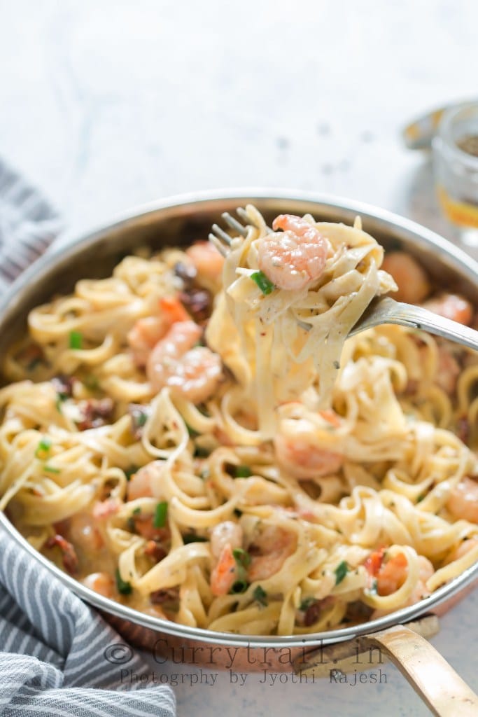 Garlic Shrimp Pasta in Creamy Sauce in a fork