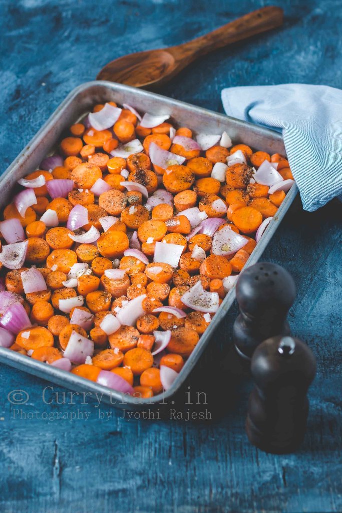 roasting carrots and onions on baking sheet to make roasted carrot soup