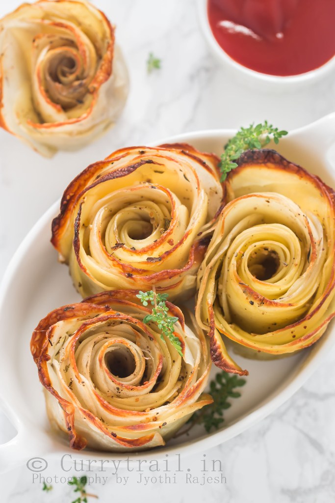 baked potato roses served in white oval ceramic dish with sauce on side
