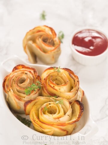 baked potato roses served in white oval ceramic dish with sauce on side