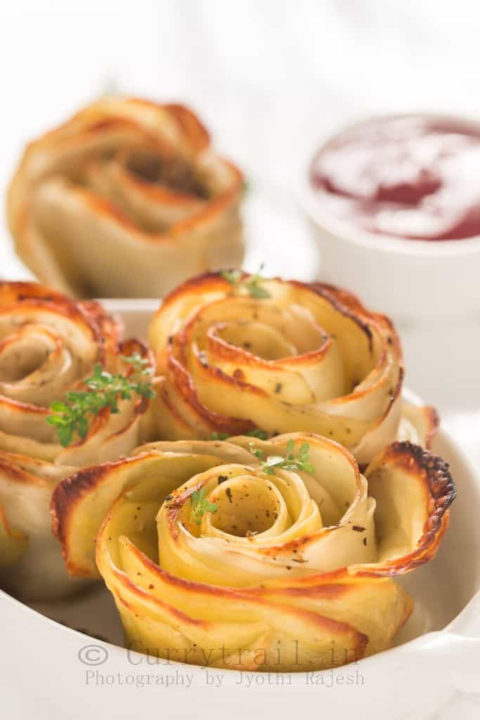 baked potato roses served in white oval ceramic dish with sauce on side