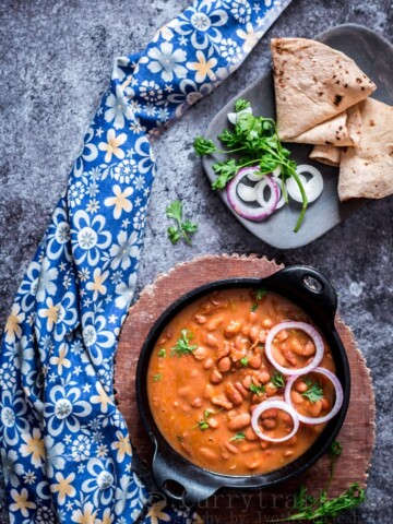 rajma masala is rich, creamy, spicy red bean curry served in cast iron pan