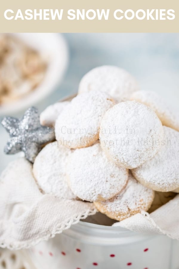 cashew snow cookies in white cookie jar with text overlay