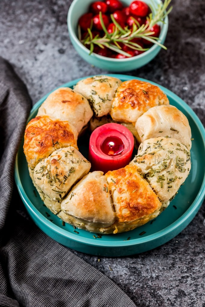 cheesy garlic and herb pull apart bread with a bowl on side