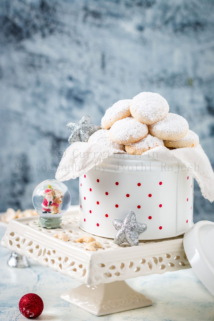 cashew snow cookies in white cookie jar