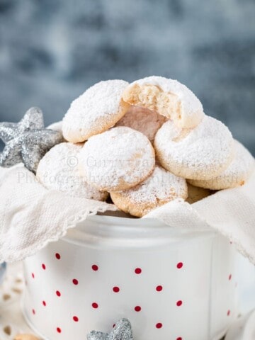 cashew snow cookies in white cookie jar