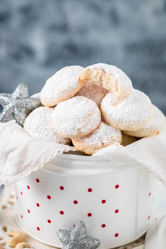 cashew snowball cookies in white cookie jar