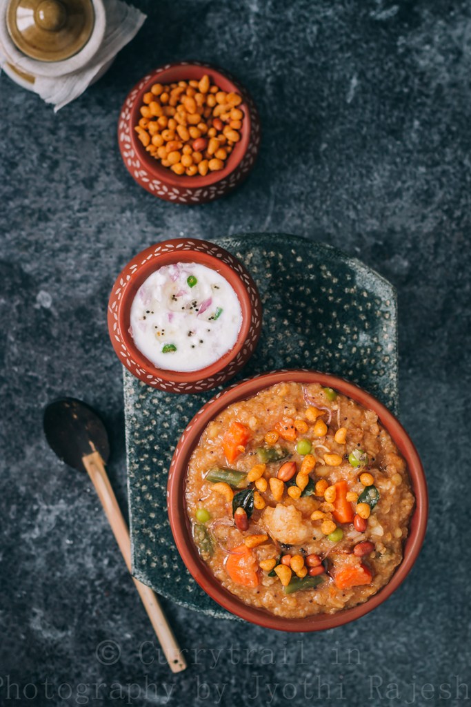 spicy bisi bele bath served with boondi and raita