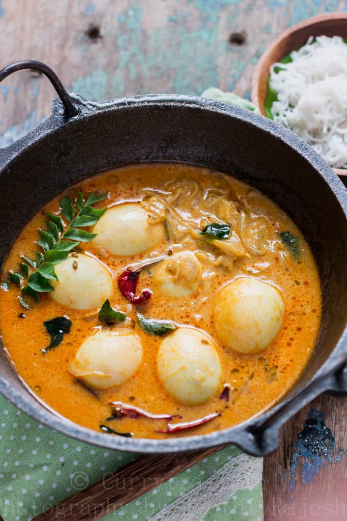 egg stew Kerala style served in cast iron pan for breakfast with rice string hoppers 