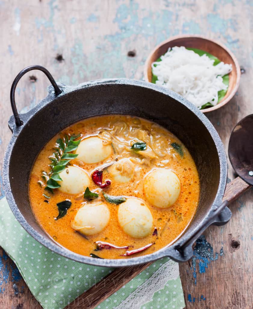 egg stew Kerala style served in cast iron pan for breakfast with rice string hoppers 