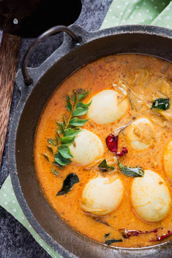 egg stew Kerala style served in cast iron pan for breakfast with rice string hoppers 