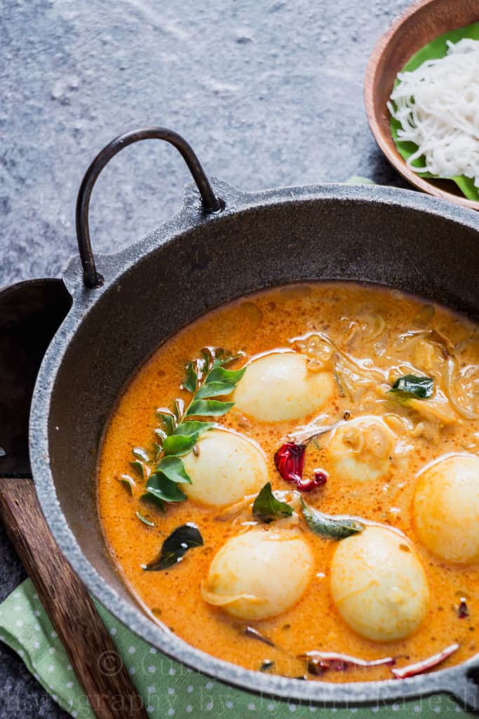 egg stew Kerala style served in cast iron pan for breakfast with rice string hoppers 