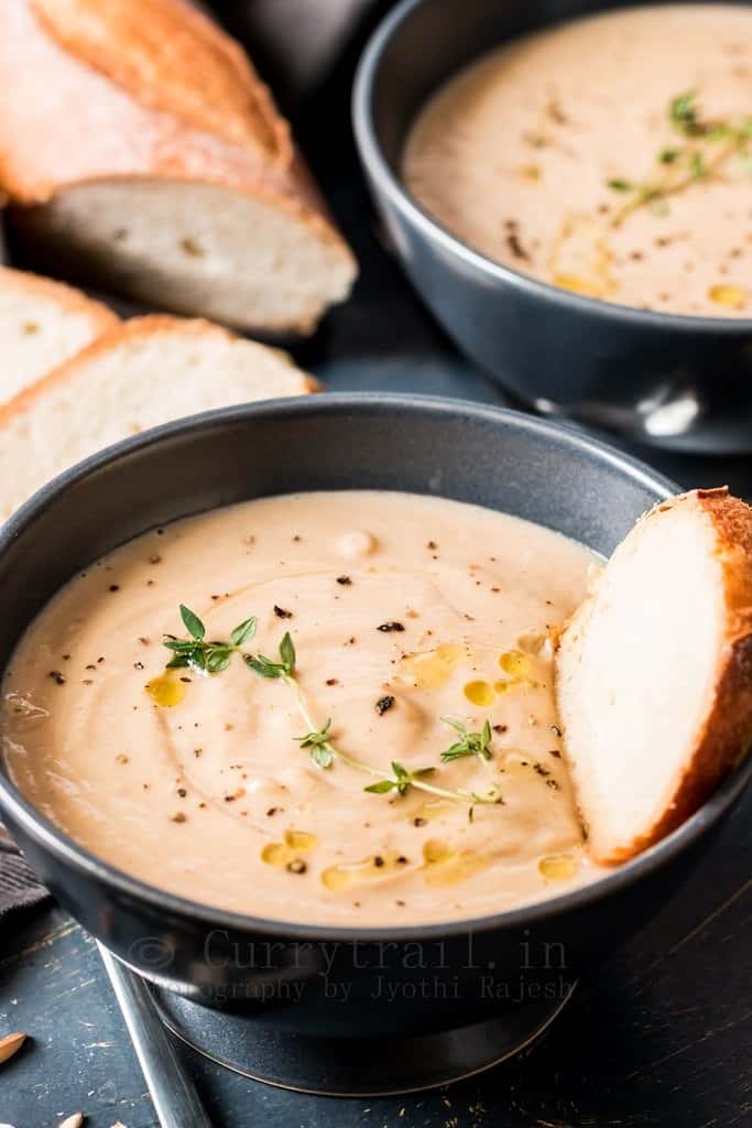 roasted cauliflower soup with almonds served in ceramic bowls