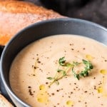 roasted cauliflower soup with almonds served in ceramic bowls