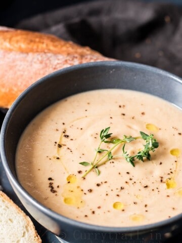 roasted cauliflower soup with almonds served in ceramic bowls