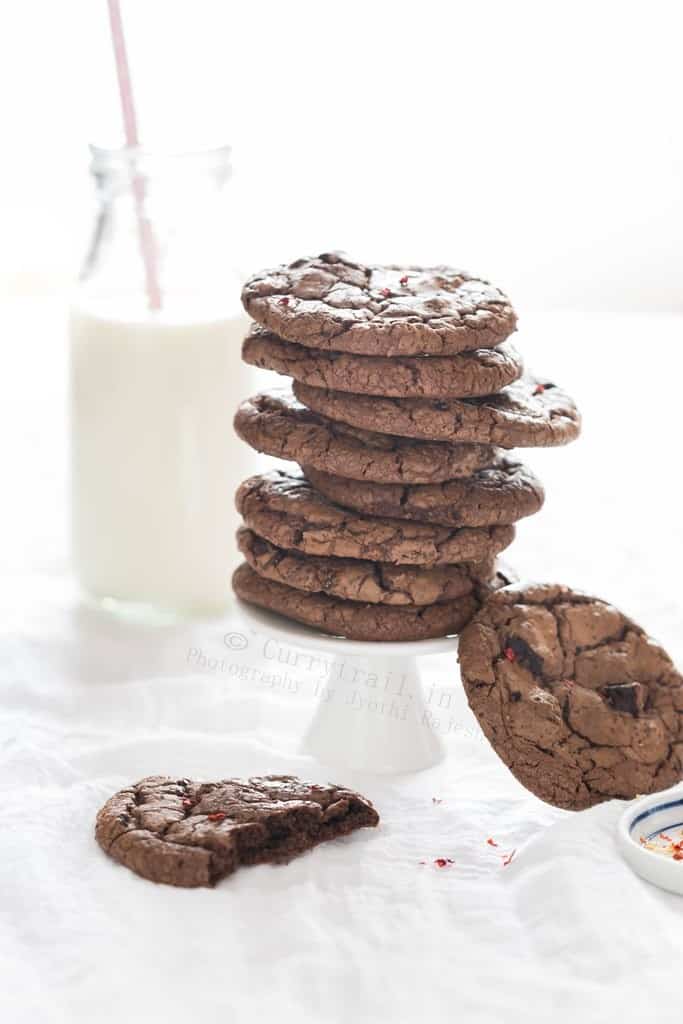 stacks of chocolate chili cookies with bottle of milk