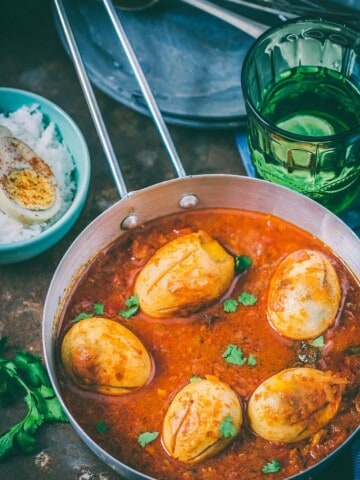 dhaba style anda curry served in skillet with rice on side