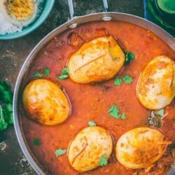 dhaba style anda curry served in skillet with rice on side