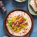 Chicken fajitas spread on flour tortillas