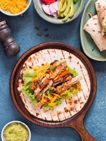 Chicken fajitas spread on flour tortillas