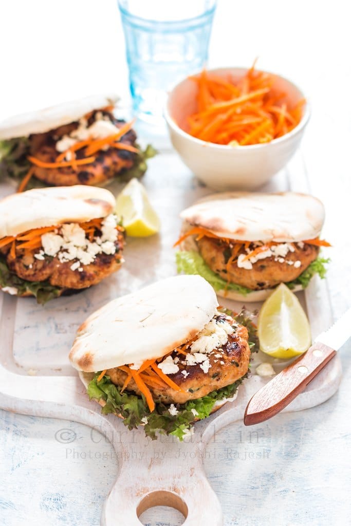 Moroccan Chicken Burgers Spread on a Boards with Bowl of Carrots