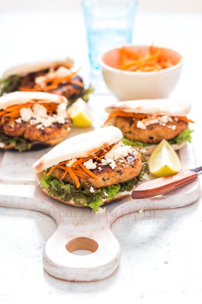 Moroccan Chicken Burgers Spread on a Boards with Bowl of carrots served on a board