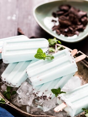 Healthy vegan mint chocolate popsicles on a tray of ice cubes