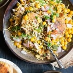 aloo tikki chaat served with chutney on sides with text overlay