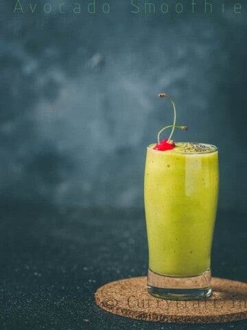 Morning healthy vegan avocado banana smoothie topped with chia seed and cherry